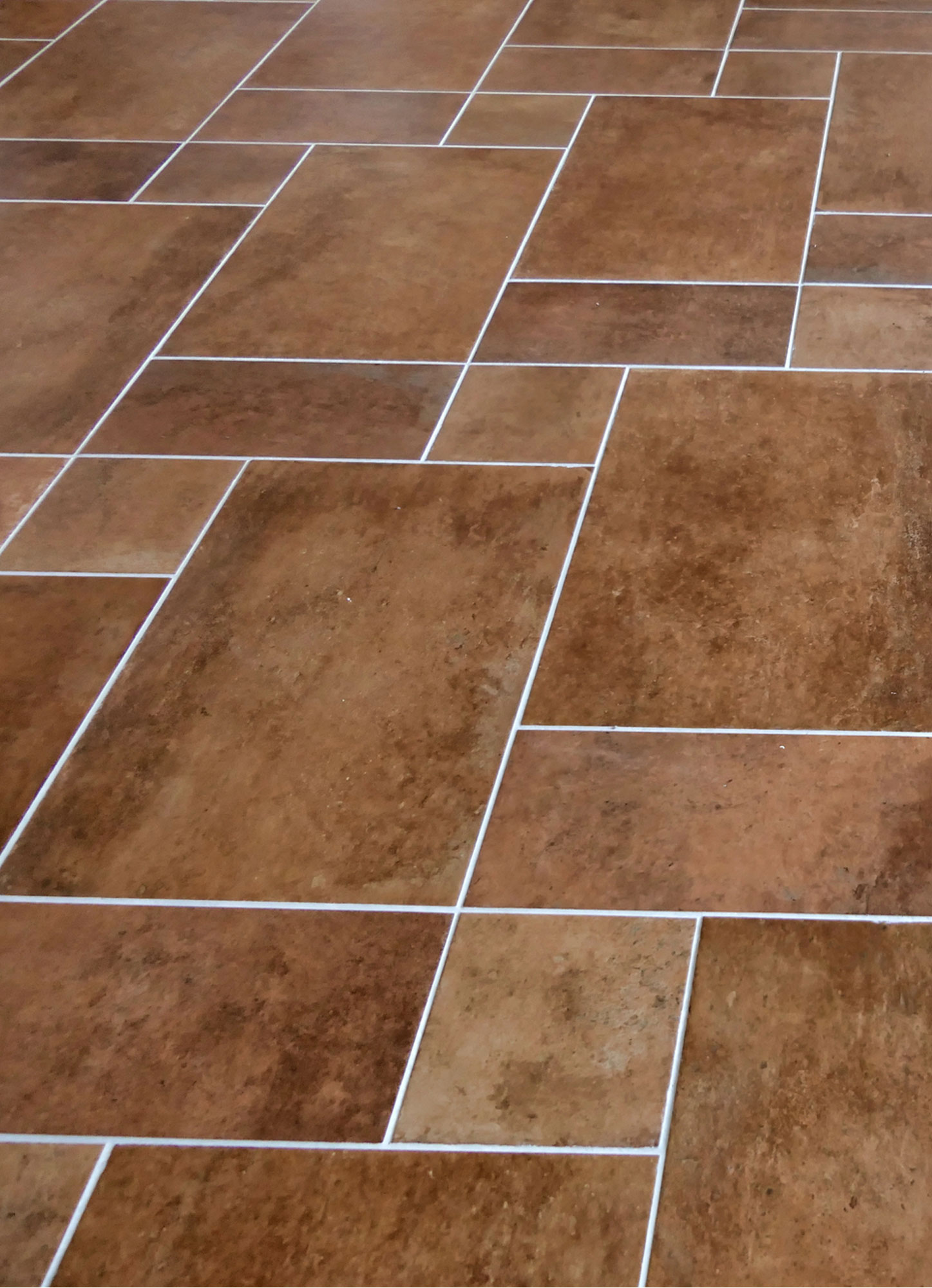 Newly-laid-Italian-terracotta-brown-floor-tiles-finished-with-grey-grouting